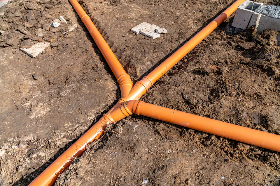 Orange pipes laid in the ground