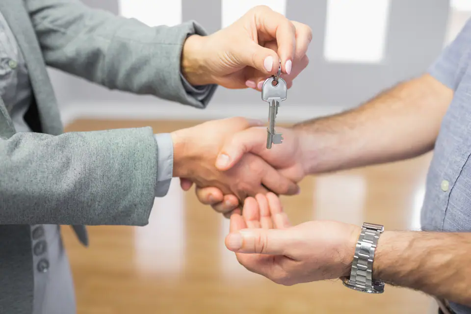 Keys being handed over with a handshake