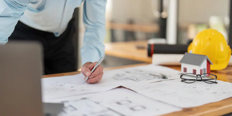 A designer working on drawings at a desk