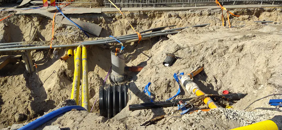 An excavation with underground utilities in a city
