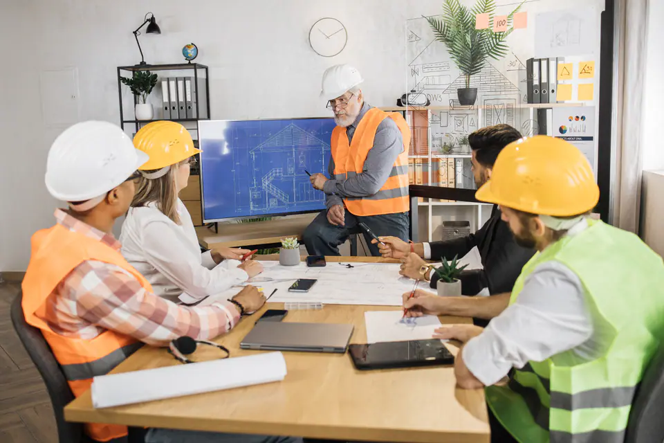 A construction team meeting over drawings