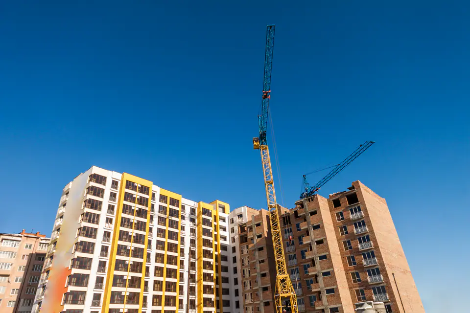 Apartment building under construction with a crane